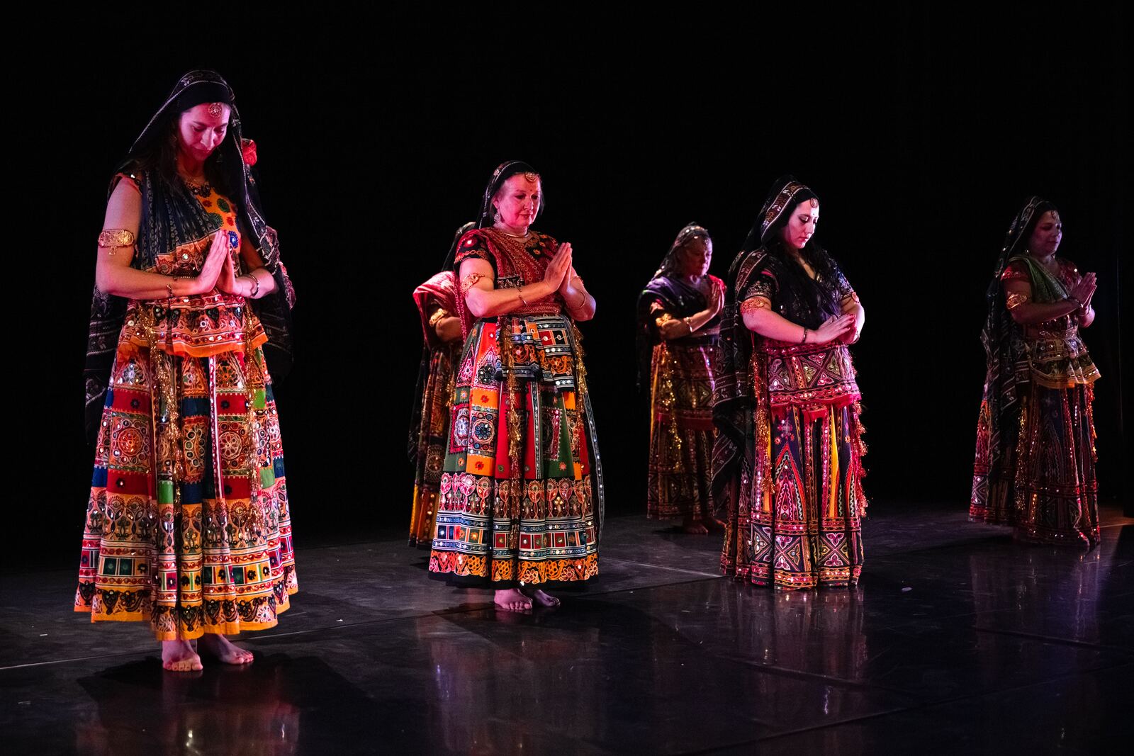 Bollyfolk students in mirror-work skirts, mid-turn.